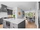 Open-concept kitchen with marble island, gray cabinetry, stainless appliances, and view to living area at 3408 Landen Pine Ne Ct, Atlanta, GA 30305