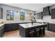 Well-lit kitchen featuring gray cabinets, a central island with seating, and modern appliances at 3408 Landen Pine Ne Ct, Atlanta, GA 30305