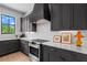 Chic kitchen features gray cabinets, white backsplash, and modern stainless steel appliances at 3408 Landen Pine Ne Ct, Atlanta, GA 30305