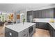Modern kitchen with stainless steel appliances, gray cabinets, and island with marble countertops at 3408 Landen Pine Ne Ct, Atlanta, GA 30305