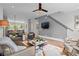 Bright, open-concept living space with stylish furnishings, hardwood floors, and modern staircase at 3408 Landen Pine Ne Ct, Atlanta, GA 30305