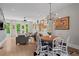 Open concept living room and dining room with hardwood floors and modern lighting at 3408 Landen Pine Ne Ct, Atlanta, GA 30305