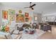 Bright, open-concept living room with hardwood floors, eclectic artwork, and ample seating arrangement at 3408 Landen Pine Ne Ct, Atlanta, GA 30305