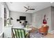 Cozy home office boasts a white desk, zebra rug, and pops of color from artwork and a vibrant guitar on the wall at 3408 Landen Pine Ne Ct, Atlanta, GA 30305