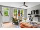 Bright home office features a ceiling fan, standing desk setup, and a zebra-print rug, offering a stylish workspace at 3408 Landen Pine Ne Ct, Atlanta, GA 30305