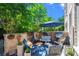 A blue umbrella provides shade for the outdoor seating on the patio surrounded by beautiful greenery at 3408 Landen Pine Ne Ct, Atlanta, GA 30305