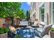 Outdoor patio seating area with a grill and a beautiful garden at 3408 Landen Pine Ne Ct, Atlanta, GA 30305