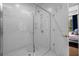 Modern shower with white tile and glass door is adjacent to a bedroom view at 3408 Landen Pine Ne Ct, Atlanta, GA 30305