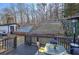 Relaxing backyard featuring a spacious wooden deck, lush greenery, wooden fence, storage shed, and plenty of room to play at 52 Buena Vista Se Cir, Cartersville, GA 30121