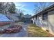 A lush backyard view featuring a back deck and patio, retaining wall, a shed, and lush green grass at 52 Buena Vista Se Cir, Cartersville, GA 30121