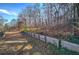 Wooded backyard with a classic wooden fence offering privacy and a rustic charm at 52 Buena Vista Se Cir, Cartersville, GA 30121