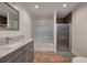 Modern bathroom with a glass-enclosed shower, vanity with marble countertop, and wood-look plank flooring at 52 Buena Vista Se Cir, Cartersville, GA 30121