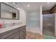 Bathroom with a glass-enclosed shower, vanity with marble countertop, and wood-look plank flooring at 52 Buena Vista Se Cir, Cartersville, GA 30121