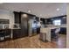 Well-lit kitchen with stainless steel appliances, dark cabinets, and a modern island at 52 Buena Vista Se Cir, Cartersville, GA 30121