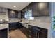Elegant kitchen featuring stainless steel appliances, dark cabinets, and marble countertops at 52 Buena Vista Se Cir, Cartersville, GA 30121