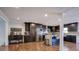Open kitchen features dark cabinetry, stainless steel appliances, a center island with seating, and hardwood floors at 52 Buena Vista Se Cir, Cartersville, GA 30121