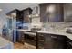 Modern kitchen equipped with stainless steel appliances, dark cabinets, and marble countertops at 52 Buena Vista Se Cir, Cartersville, GA 30121