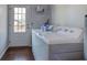 Functional laundry room featuring a washer, dryer, utility sink, and easy access to the outdoors through a glass door at 52 Buena Vista Se Cir, Cartersville, GA 30121