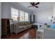 Cozy living room features bright windows, hardwood floors, couch, cabinet and dining table at 52 Buena Vista Se Cir, Cartersville, GA 30121