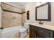 Well-appointed bathroom featuring stone tiles, a modern vanity, and shower-tub combo at 610 Mill Pond Se Dr, Smyrna, GA 30082