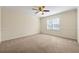 Bright bedroom with neutral carpet, base molding, and a ceiling fan at 610 Mill Pond Se Dr, Smyrna, GA 30082