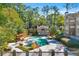 Inviting community pool area surrounded by lush trees, lounge chairs, and a charming cabana at 610 Mill Pond Se Dr, Smyrna, GA 30082