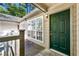 Charming condo entryway featuring a green front door, wood deck, and lots of natural light at 610 Mill Pond Se Dr, Smyrna, GA 30082