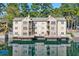 Condo with exterior balconies overlooking a serene lake creating a picturesque waterfront living experience at 610 Mill Pond Se Dr, Smyrna, GA 30082