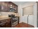 Modern kitchen features stainless steel appliances and custom cabinetry, plus a laundry closet at 610 Mill Pond Se Dr, Smyrna, GA 30082