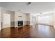 Inviting living room with a cozy fireplace, large windows, and gleaming hardwood floors at 610 Mill Pond Se Dr, Smyrna, GA 30082