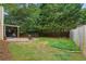 Backyard with a stone patio featuring chairs and a built in fire pit with covered wooden pergola nearby at 865 Ashfield Dr, Decatur, GA 30030