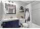 Bright bathroom with a sink, toilet, shower with frog curtain, wood shelves and a dark vanity at 865 Ashfield Dr, Decatur, GA 30030