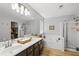 Bright bathroom features a double sink vanity, soaking tub, and glass-enclosed shower with modern fixtures at 865 Ashfield Dr, Decatur, GA 30030