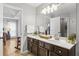 Bathroom with double sinks, white countertops, dark wood cabinets, and a view into the bedroom at 865 Ashfield Dr, Decatur, GA 30030