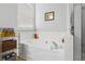 Close up of a soaking tub with a view of a bathroom window and decorative shelving at 865 Ashfield Dr, Decatur, GA 30030