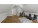 Large, open bedroom with a sloped ceiling, wood floor, futon and desk that is perfect as a guest room at 865 Ashfield Dr, Decatur, GA 30030