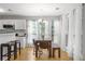 Bright dining area featuring lots of windows and white cabinets with a cozy table and stools for casual dining at 865 Ashfield Dr, Decatur, GA 30030