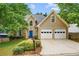 Beautifully landscaped home with a striking blue front door and a two-car garage, complemented by lush greenery at 865 Ashfield Dr, Decatur, GA 30030