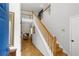 Inviting foyer featuring a staircase and hardwood floors, leading to a living area with a cozy fireplace at 865 Ashfield Dr, Decatur, GA 30030