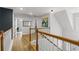 Upstairs hallway with hardwood floors and an art decorated accent wall at 865 Ashfield Dr, Decatur, GA 30030