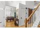 Hallway with dining room, staircase, a barn door, and hardwood flooring at 865 Ashfield Dr, Decatur, GA 30030