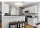 Bright kitchen with white cabinets, breakfast bar, and stainless steel microwave offering modern convenience for cooking at 865 Ashfield Dr, Decatur, GA 30030