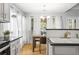 Bright kitchen with white cabinets, black countertops, and a wooden dining table near the window at 865 Ashfield Dr, Decatur, GA 30030