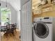 Laundry room with a front-load washing machine and shelving for storage in a naturally lit space at 865 Ashfield Dr, Decatur, GA 30030