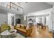 Spacious and bright living area with hardwood floors, a cozy sofa, and an open floor plan connected to kitchen at 865 Ashfield Dr, Decatur, GA 30030