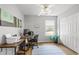 Bright office with a ceiling fan, wood floors, a large window, and a printer sitting on top of the desk at 865 Ashfield Dr, Decatur, GA 30030