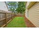 A grassy side yard is surrounded by a tall, wood fence for maximum privacy at 865 Ashfield Dr, Decatur, GA 30030