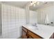Bathroom featuring a single vanity and a shower with a white shower curtain and lighting fixture at 2143 Yancey Ne Ln, Atlanta, GA 30319