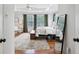 Sun-filled bedroom with a patterned rug, ceiling fan, and large windows and a full-length mirror at 2143 Yancey Ne Ln, Atlanta, GA 30319