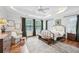 Bright and sunny bedroom with large windows, light-colored bedding, and a ceiling fan at 2143 Yancey Ne Ln, Atlanta, GA 30319
